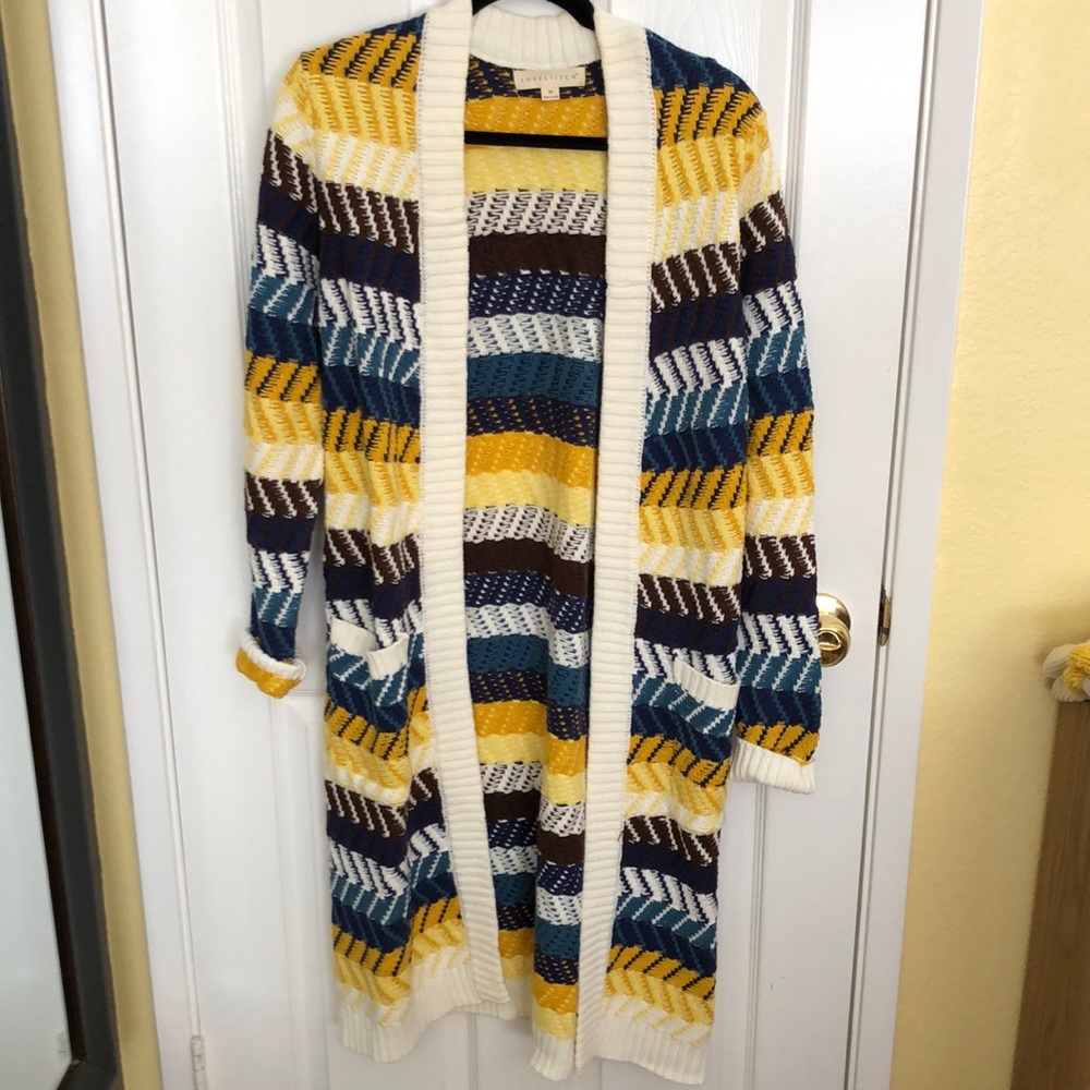 Colorful cardigan with yellow, black, white and blue.